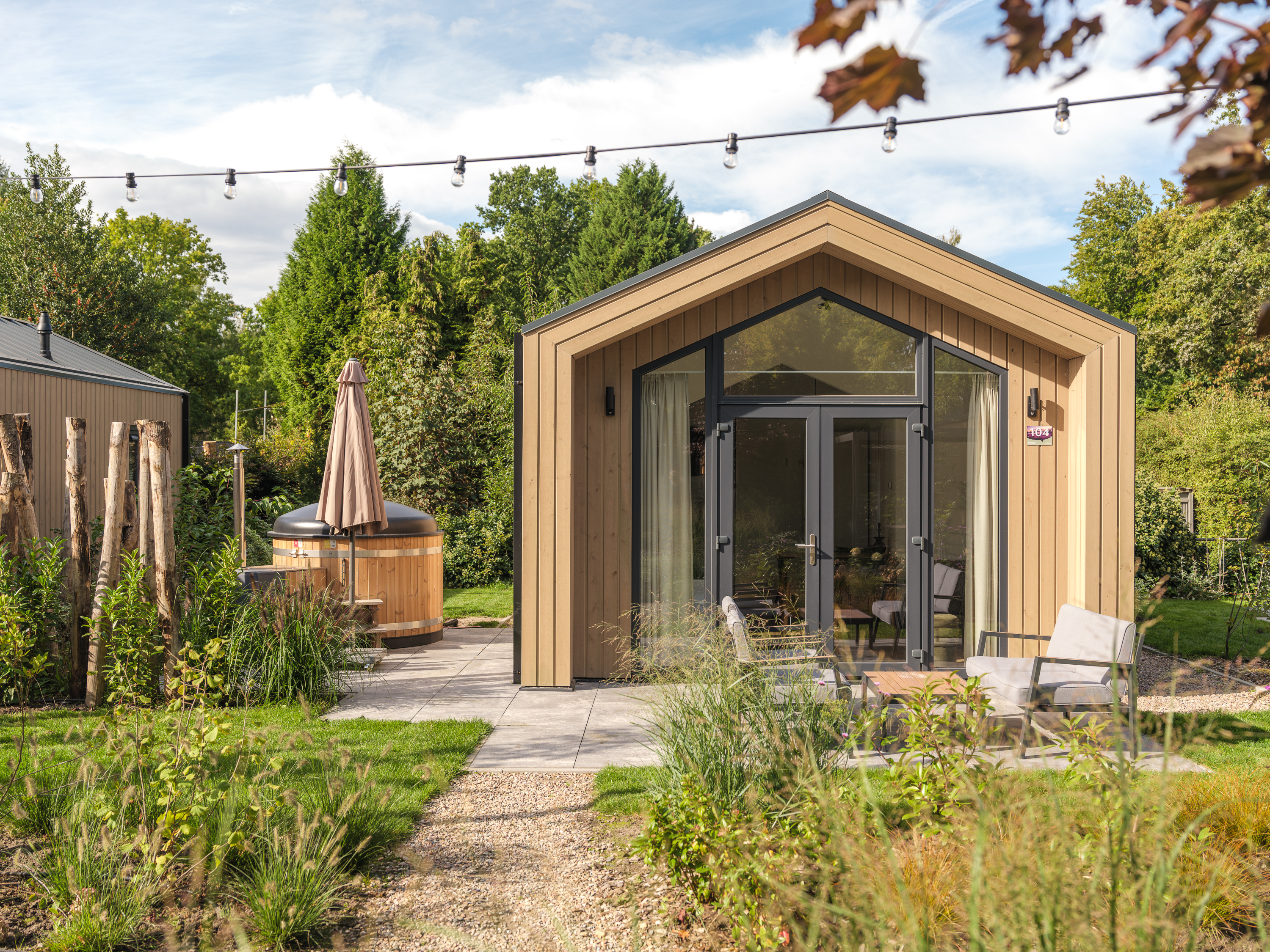 Ervaar luxe en natuur in de Tiny Lodge op de Veluwe! Gelijkvloers met 2 slaapkamers, een volledig uitgeruste keuken, airconditioning en een privé hot tub in de tuin.